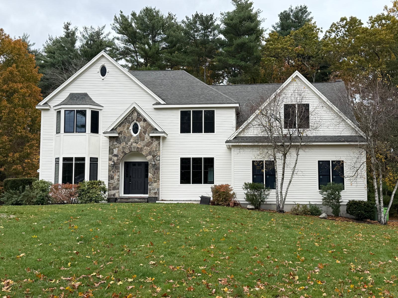 White colonial home with stone entry